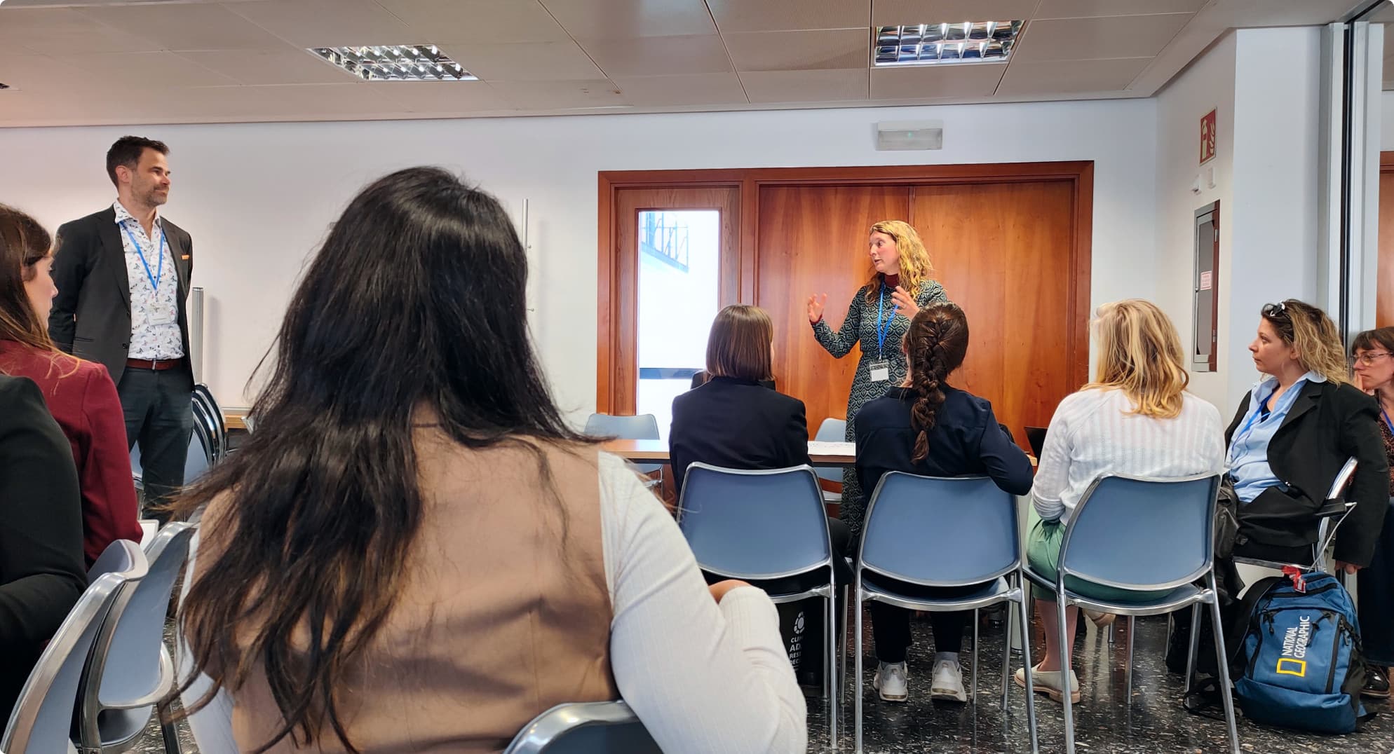 presenting to an engaged audience of diverse individuals seated in a conference room