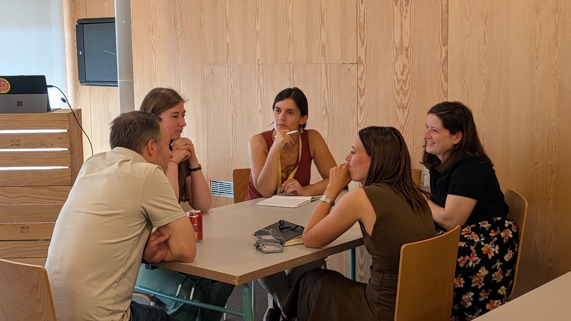 People talking seated on a table.